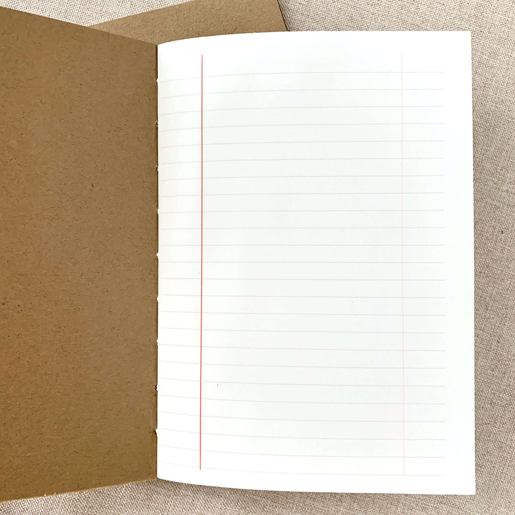 A6 lined notebook insert open flat with red vertical guideline