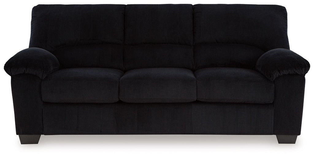 Black sofa with tufted back cushions and rounded rolled arms