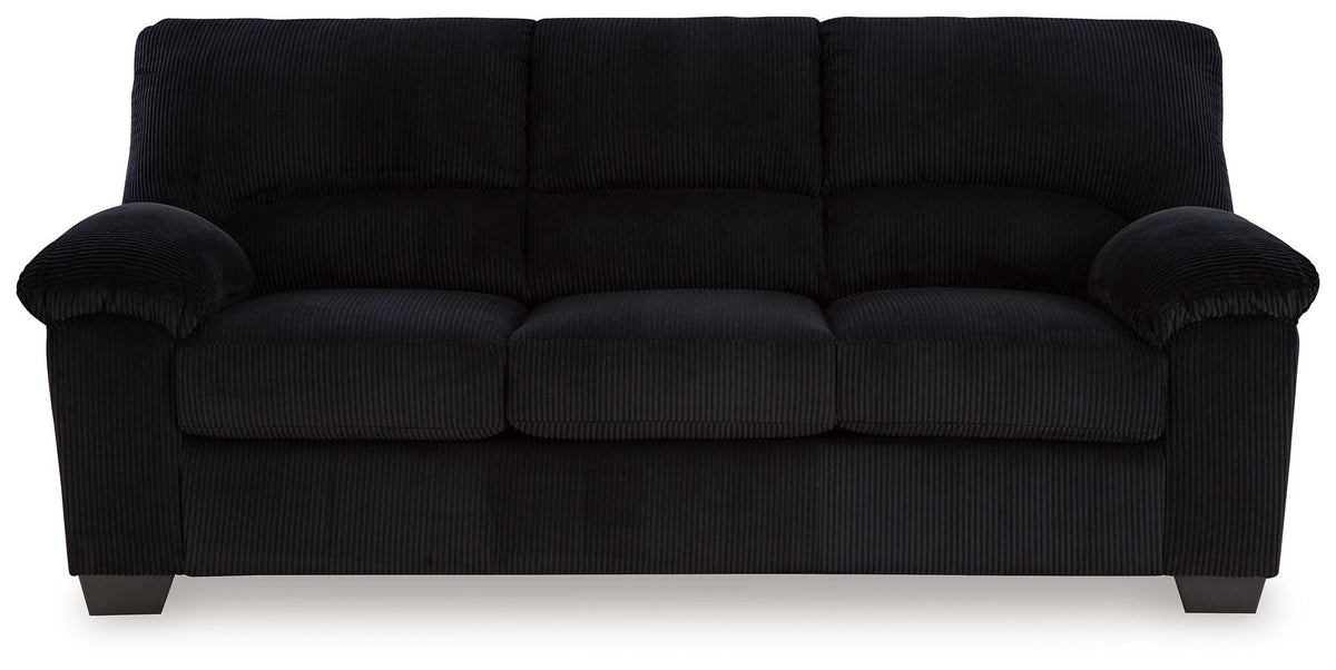 Black sofa with tufted back cushions and rounded rolled arms