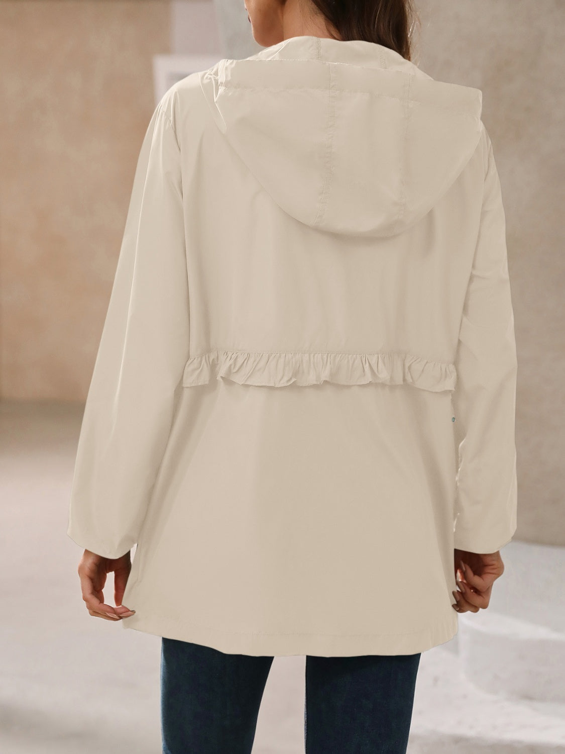 Tan hooded windbreaker jacket, back view with hood and gathered ruffle hem