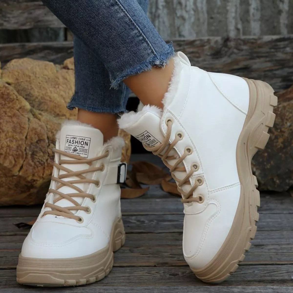 White warm-lined ankle boots showing lace-up and side buckle detail