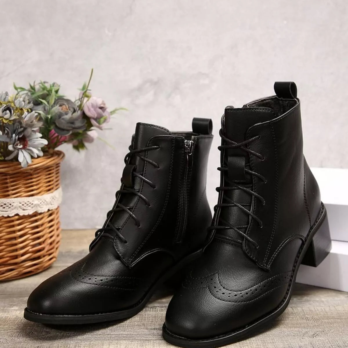 Black lace-up ankle boots with side zipper, classic brogue-style toe and block heel