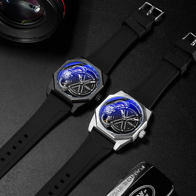 Two tonneau skeleton quartz watches with blue luminous dials and black silicone straps