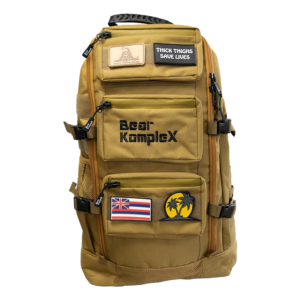 BKX desert tan military backpack front view with multiple zip pockets and patch badges