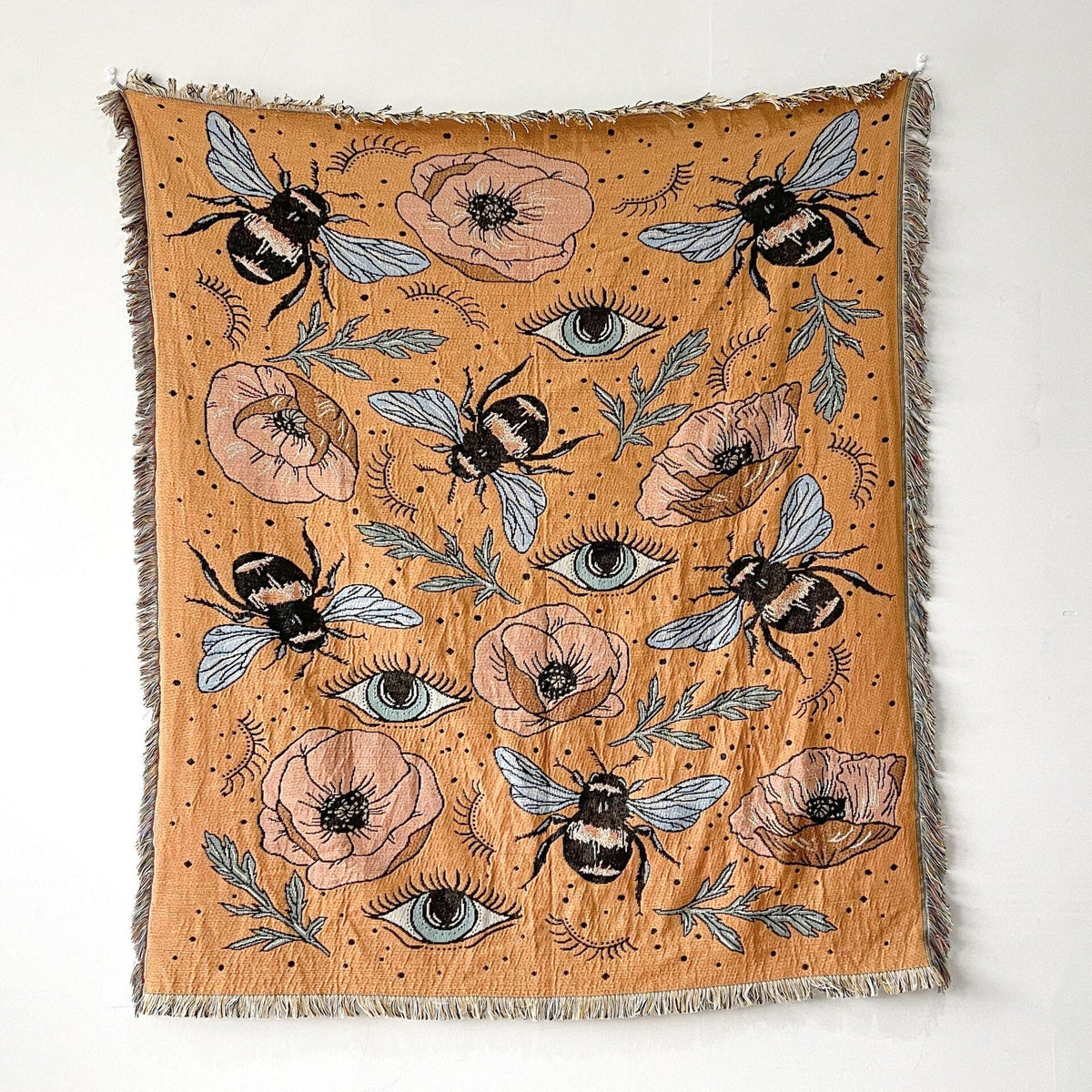 Camel-colored towel blanket with evil-eye and floral motifs, fringed border