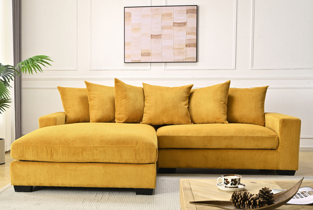 Yellow L-shaped sectional sofa with chaise, tufted cushions and striped fabric.