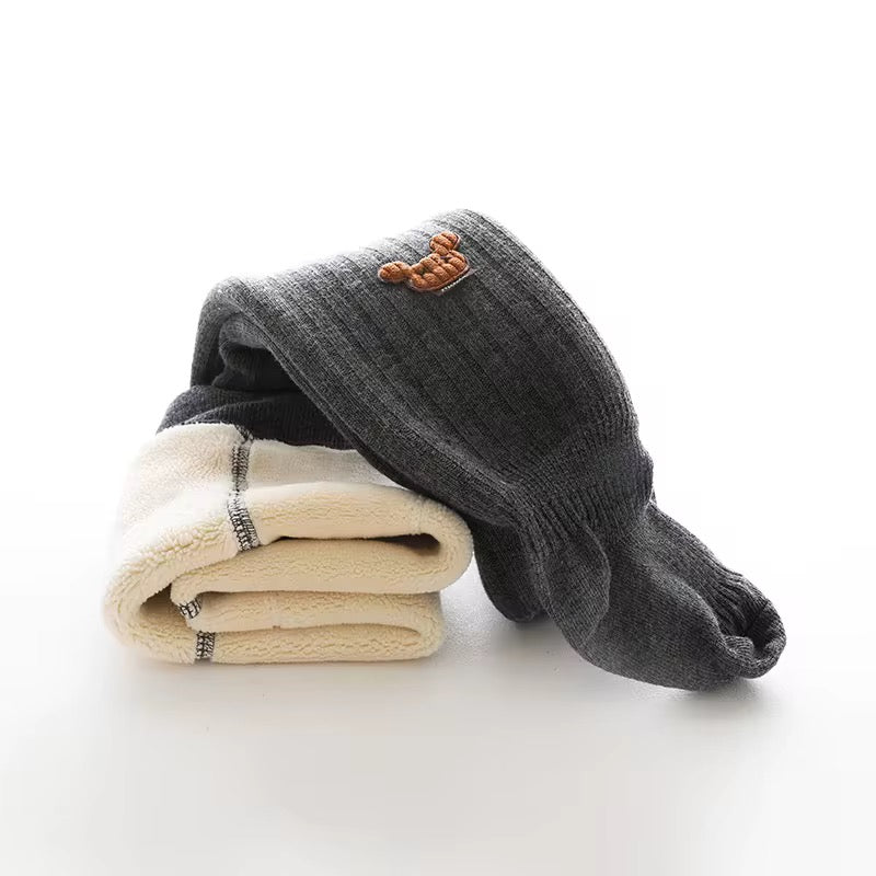 Dark gray footed leggings with ribbed knit and bear patch, folded with light leggings