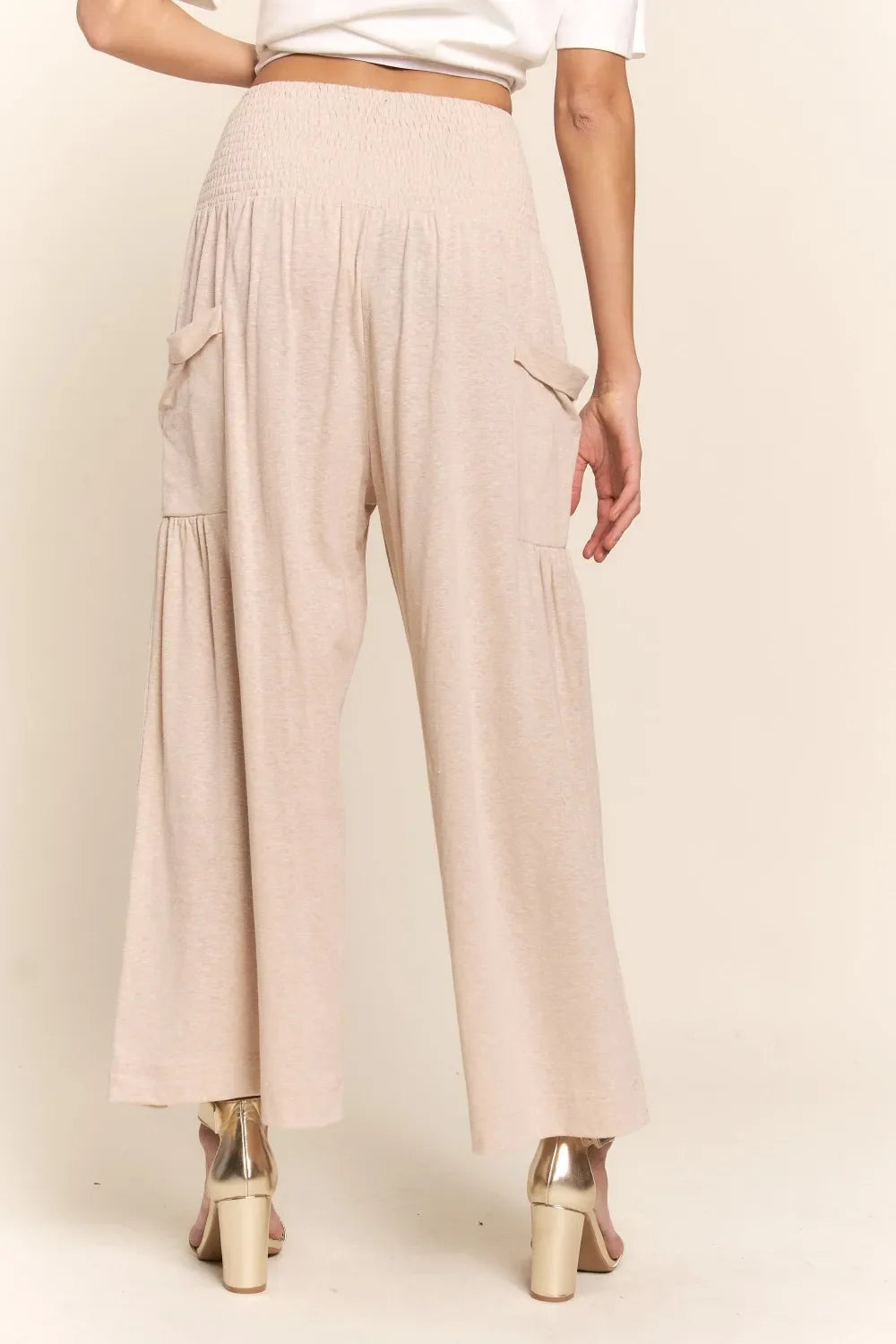 Light beige smocked-waist wide-leg pants with flap side pockets