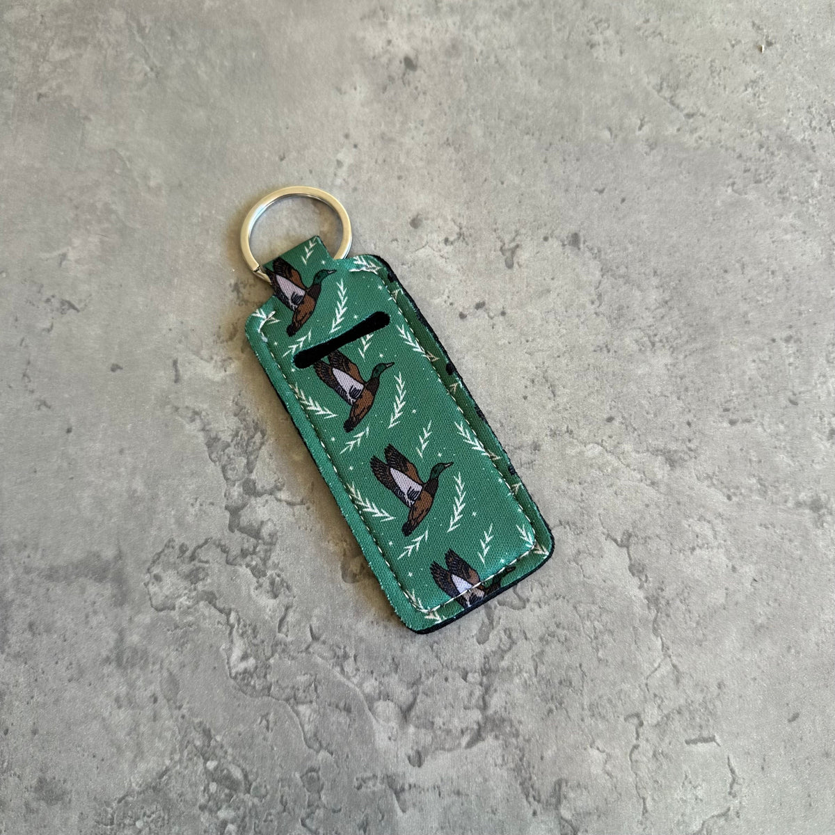 Green fabric chapstick holder keychain with bird and leaf print