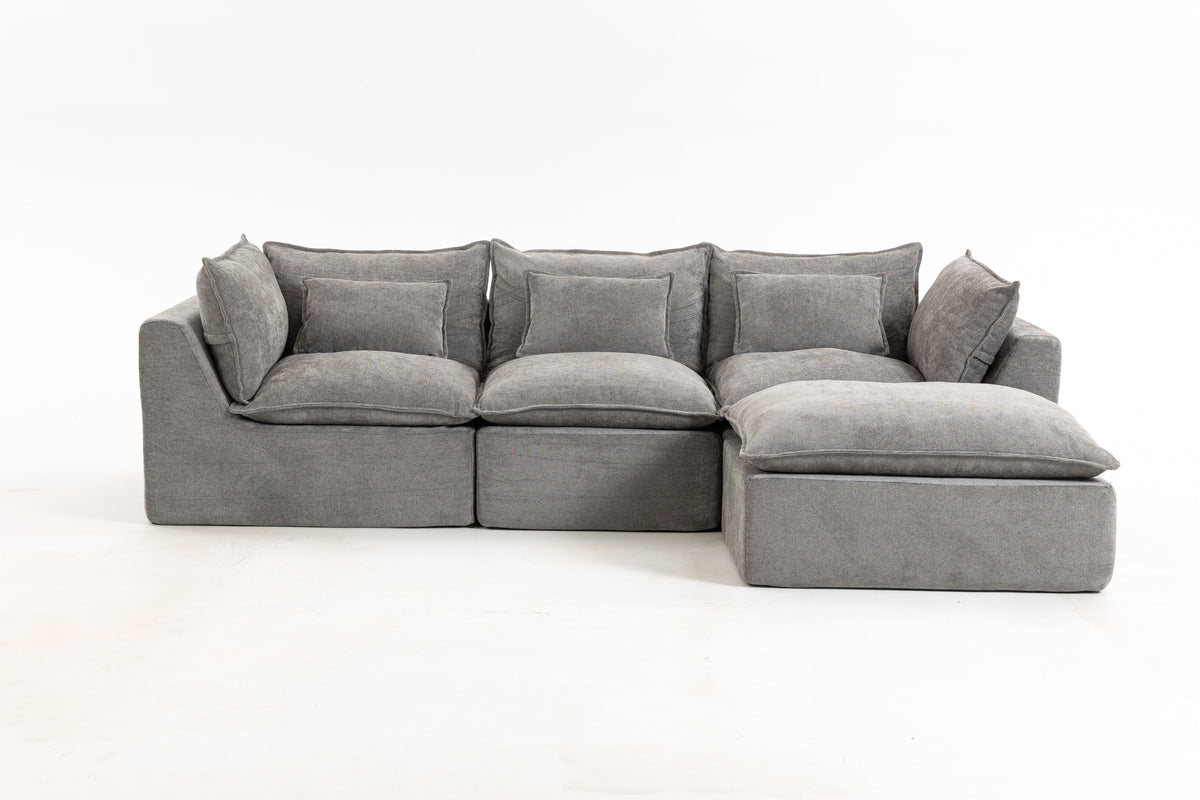 Gray modular sectional sofa with chaise ottoman and tufted-looking seat cushions