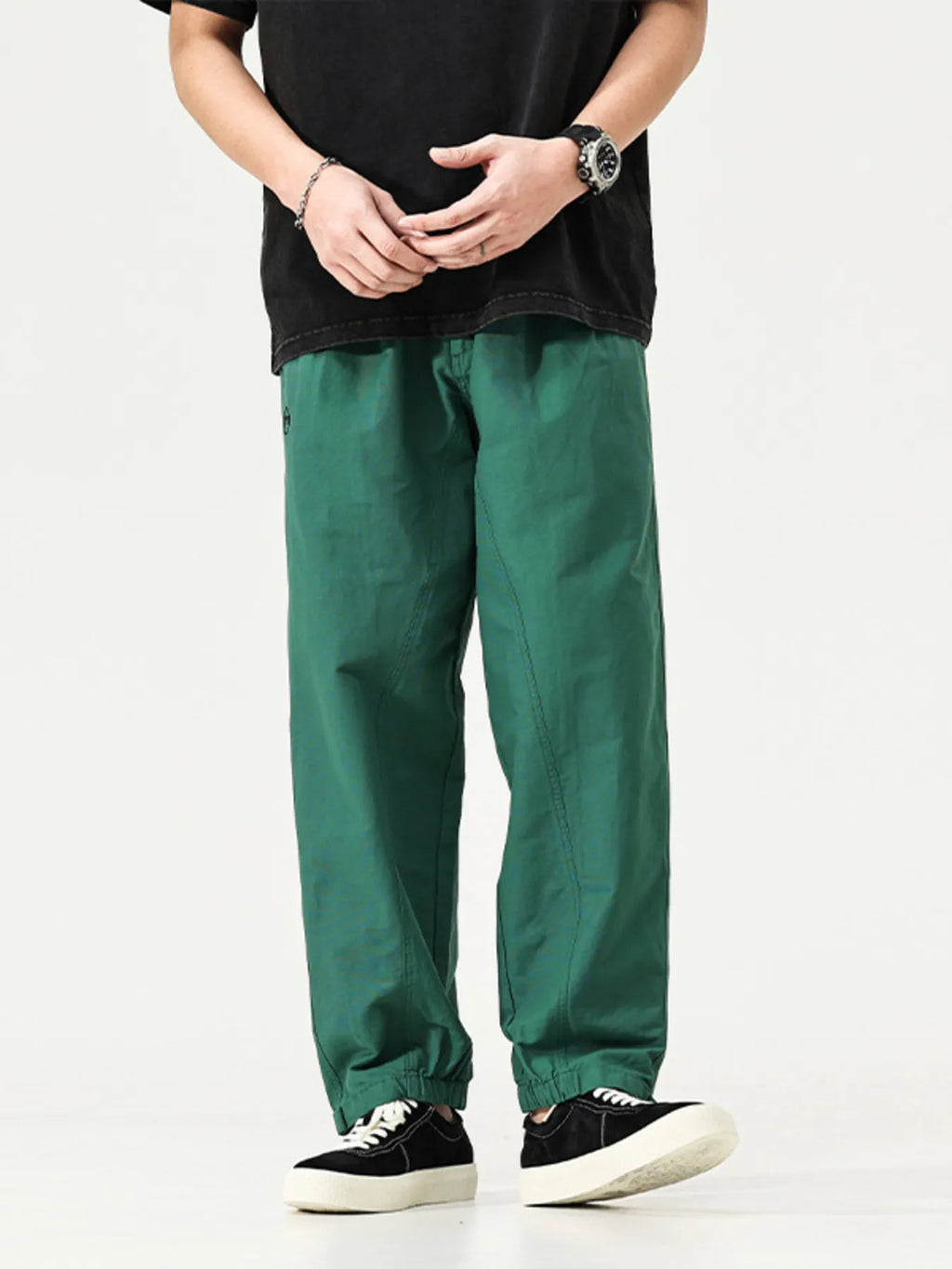 Men's emerald green cargo pants, loose fit with adjustable cuffs and side pockets