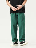 Men's emerald green cargo pants, loose fit with adjustable cuffs and side pockets