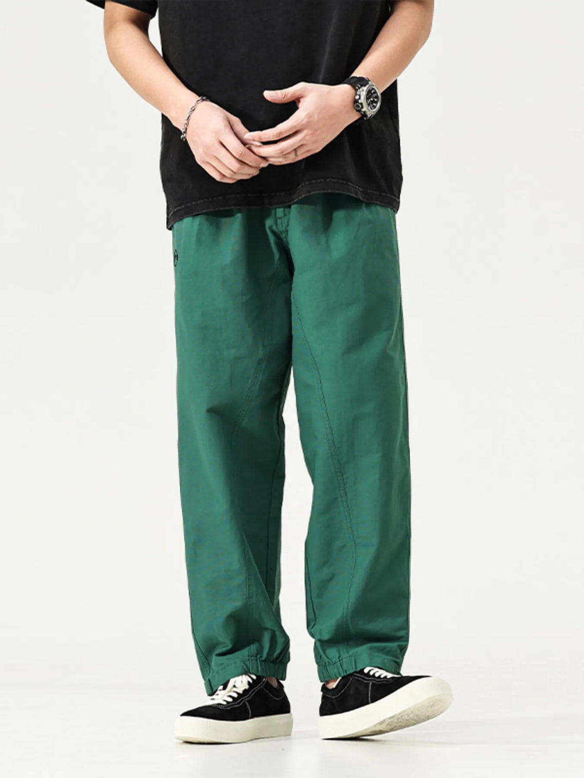 Men's emerald green cargo pants, loose fit with adjustable cuffs and side pockets