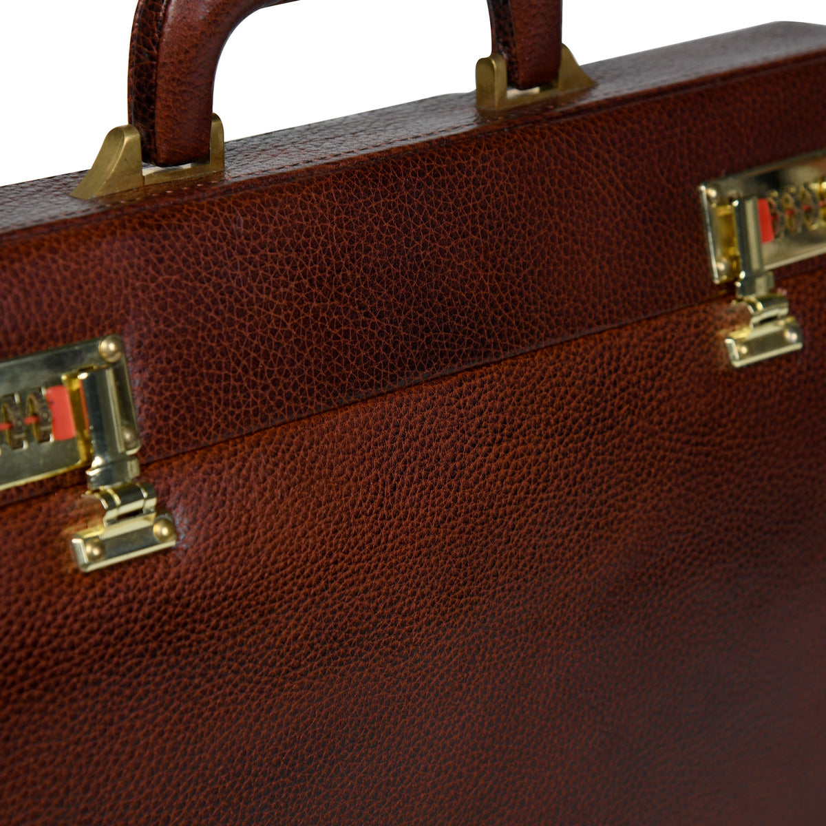 Close-up of rich brown leather suitcase front with brass locks and metal hardware