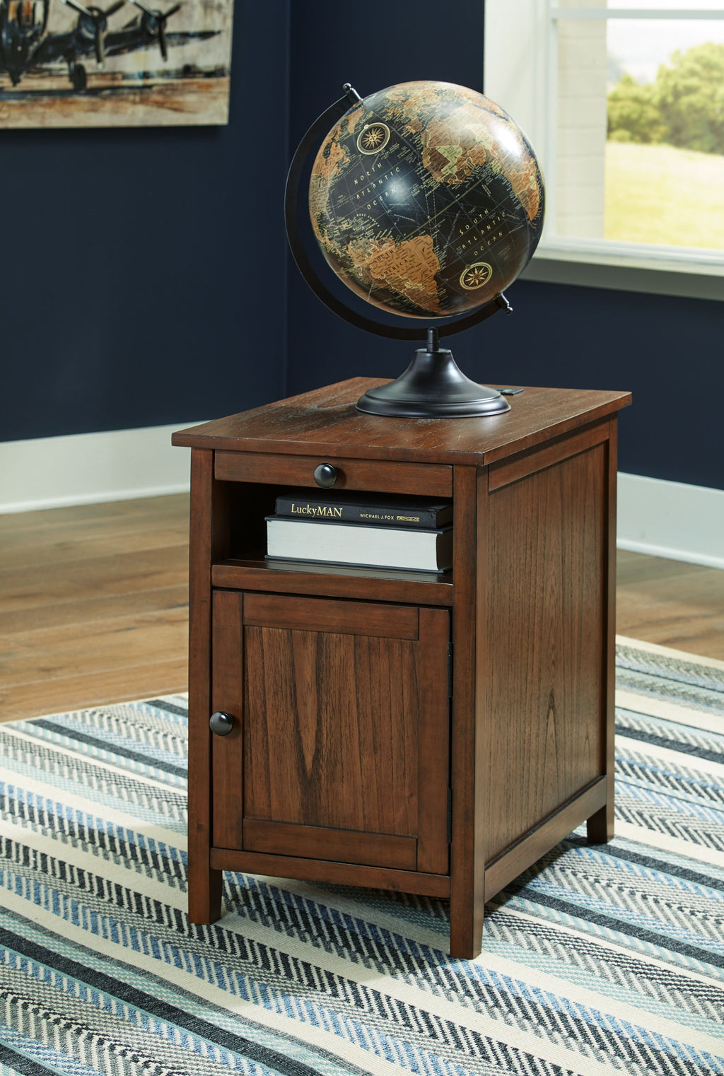 Brown wood chair side end table with cabinet door, open shelf, and round knobs