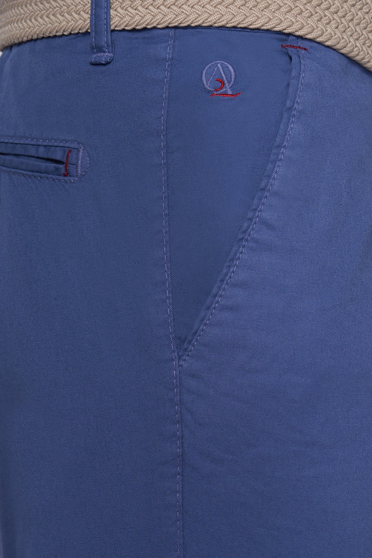 Blue shorts with stitched waistband and small logo near front pocket.