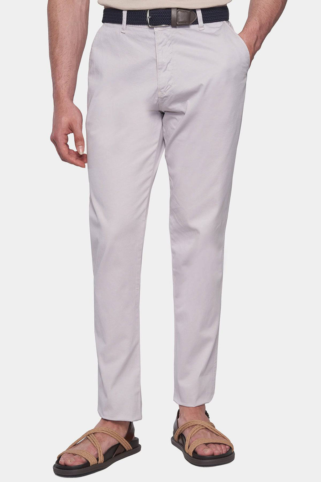 Off-white chino pants with belt loops, zip fly, and front slant pockets