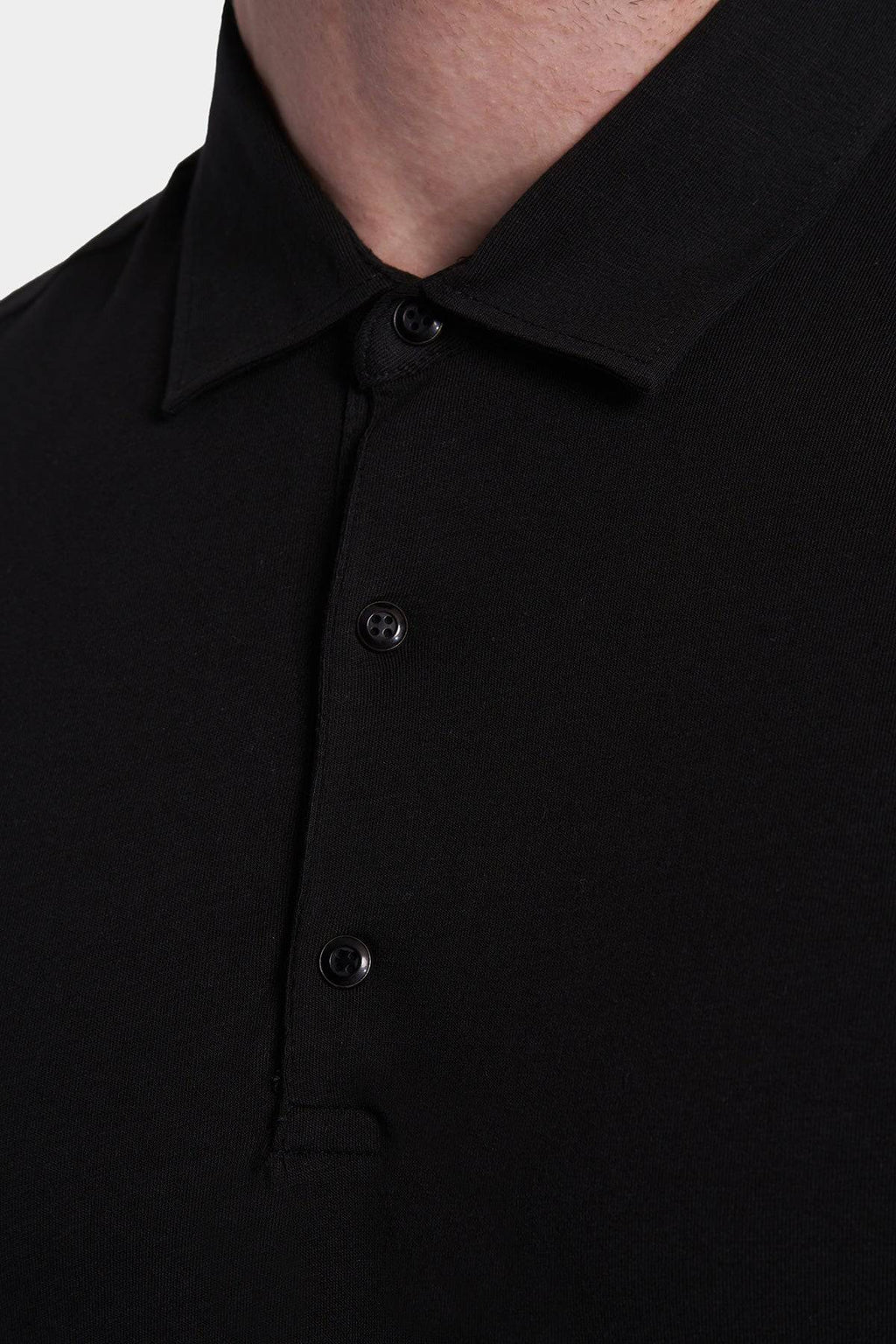 Black polo placket with three-button front and folded collar