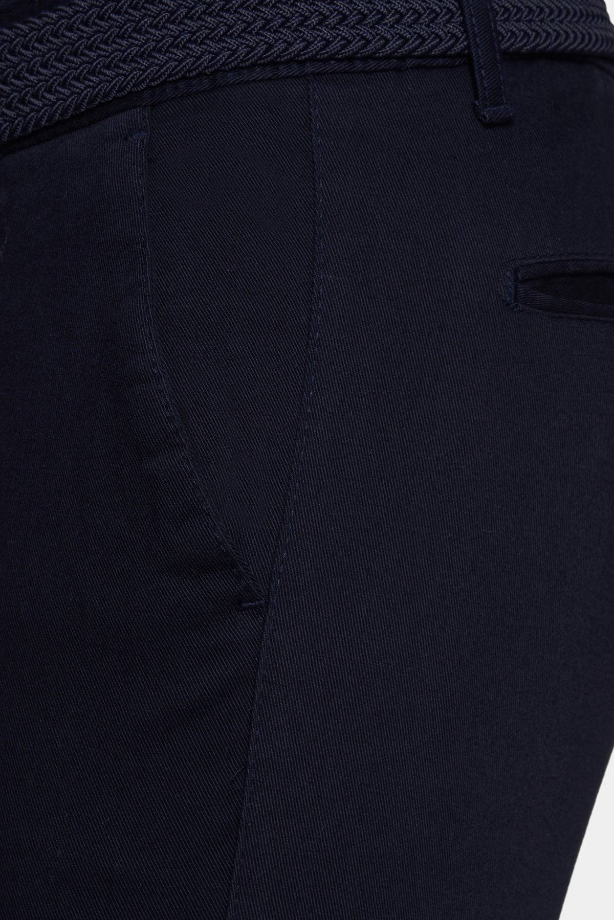 Navy chino close-up showing zipper fly, front seam, and pocket stitching