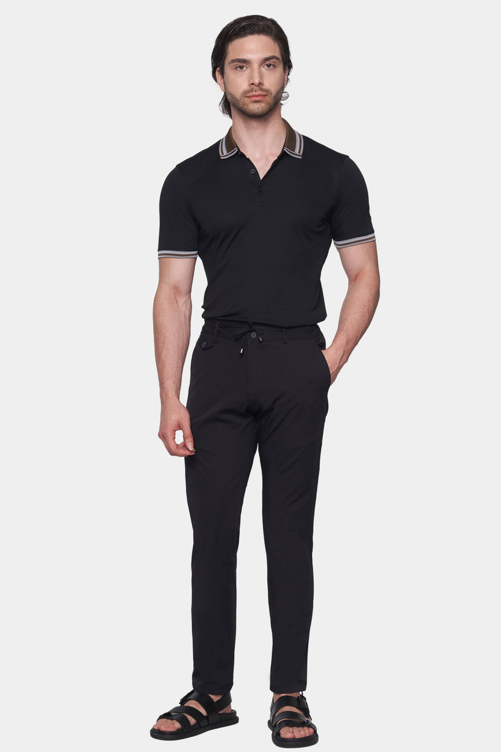 Black polo shirt with brown striped collar, short sleeves, and button placket