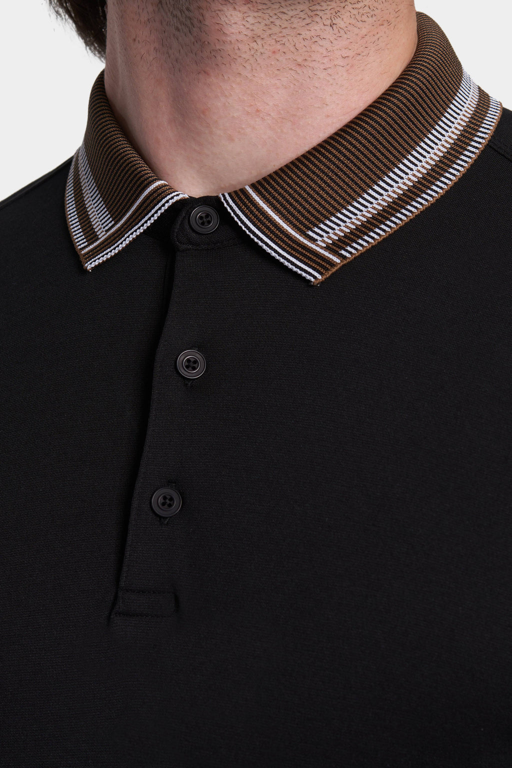 Black polo collar with brown striped trim and two-button placket