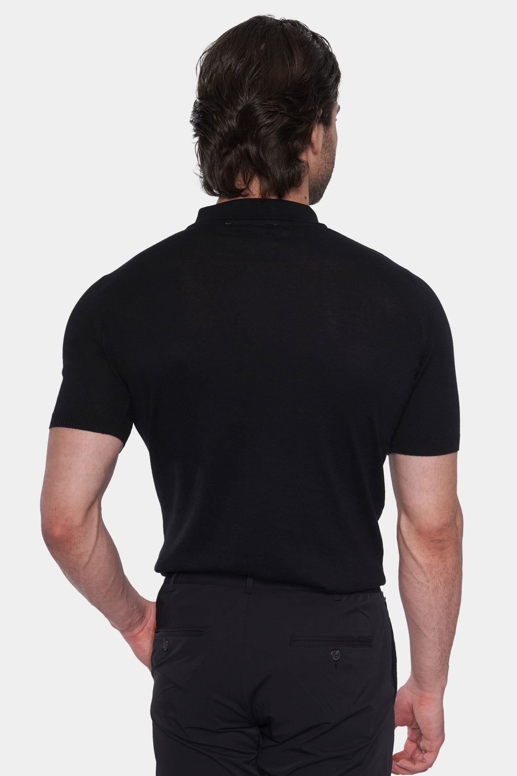 Back view of black knit cotton polo with short sleeves and ribbed collar