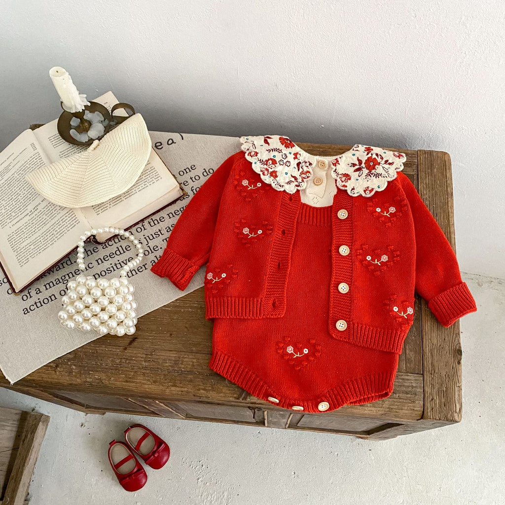 Red knit baby girl cardigan romper with cream ruffled collar, front buttons, heart embroidery