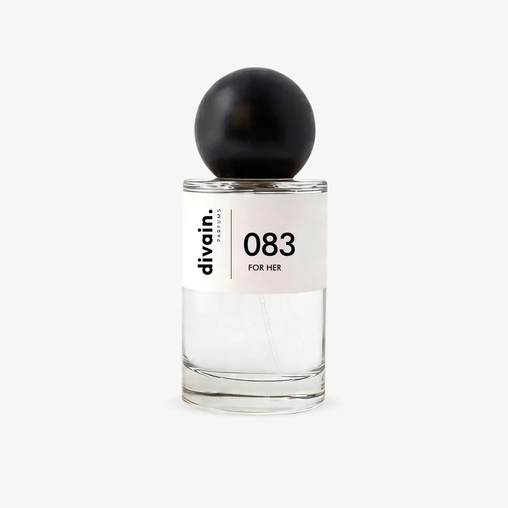 Perfume bottle with black cap and glass body, '083 for her' label on front.