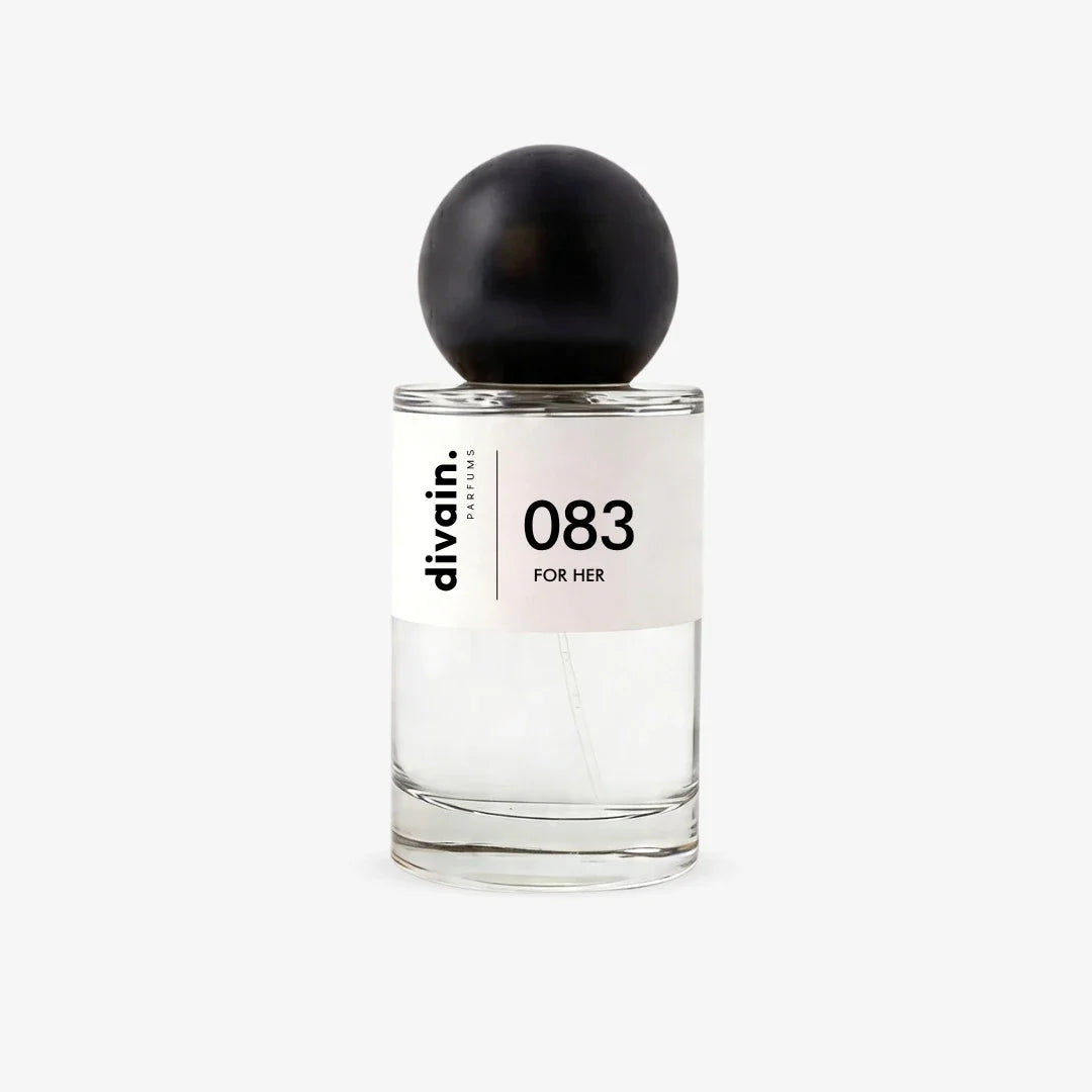 Perfume bottle with black cap and glass body, '083 for her' label on front.