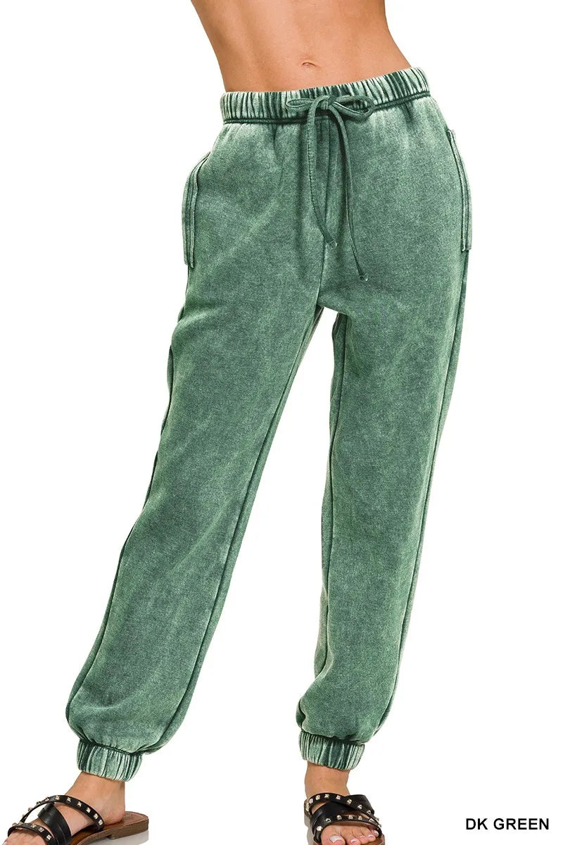Dark green acid-wash fleece sweatpants with drawstring waist and side pockets, cuffed hems