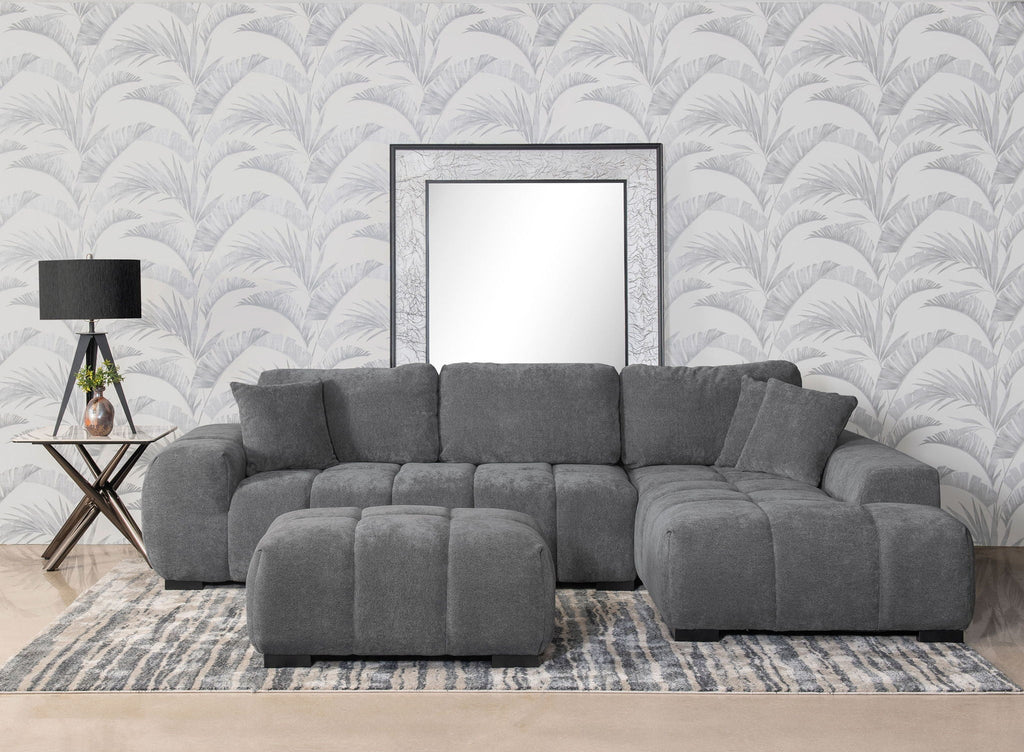 Charcoal gray upholstered sectional chaise sofa with tufted seat cushions and rolled arms