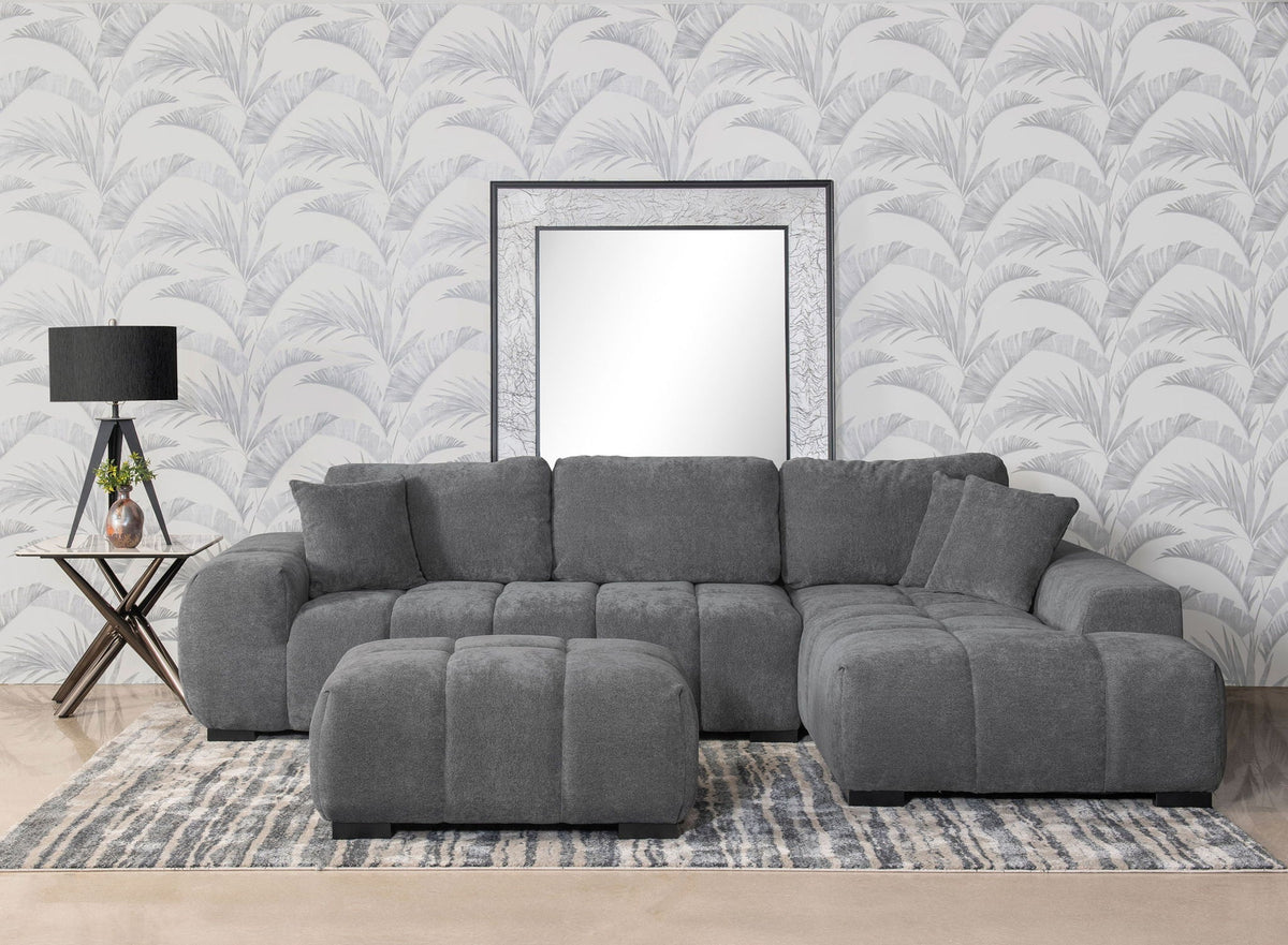 Charcoal gray upholstered sectional chaise sofa with tufted seat cushions and rolled arms