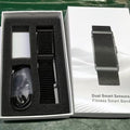 Smart fitness bracelet with black woven strap and metallic sensor module in box