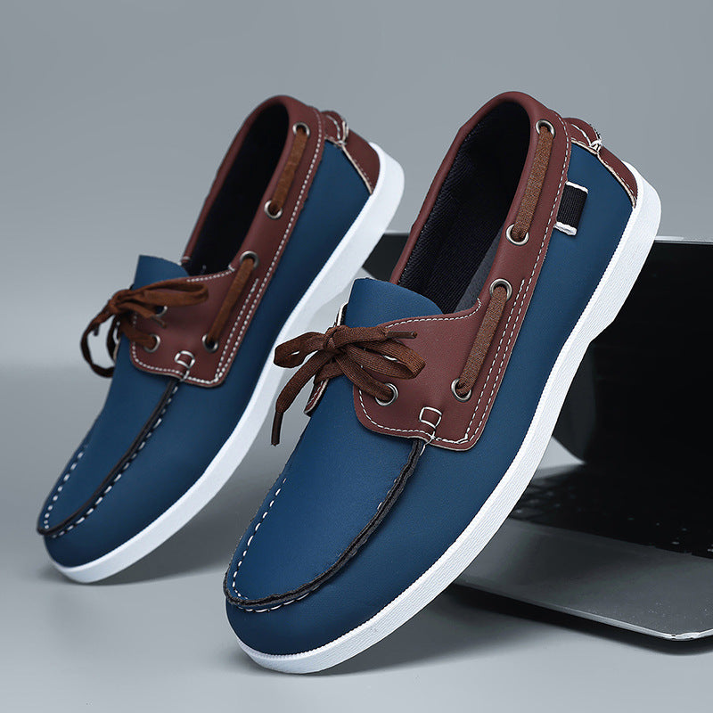 Men's blue loafers with brown trim, white soles, and brown laces