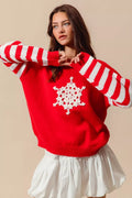 Red knit sweater with red-and-ivory striped sleeves and white crochet snowflake applique