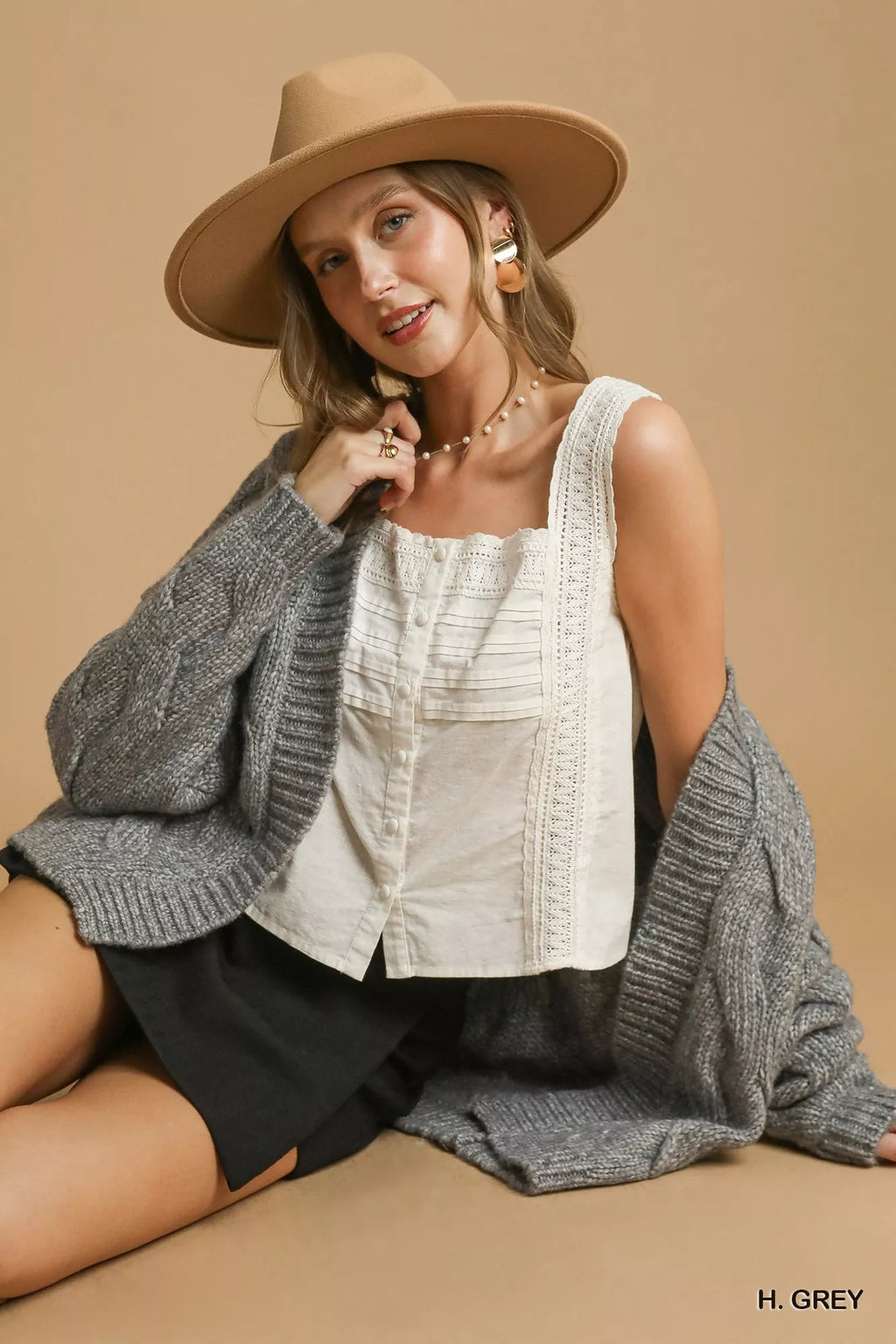 Grey cable-knit open-front cardigan with long sleeves and relaxed drape