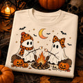 White Halloween graphic tee with two ghost figures by an orange campfire