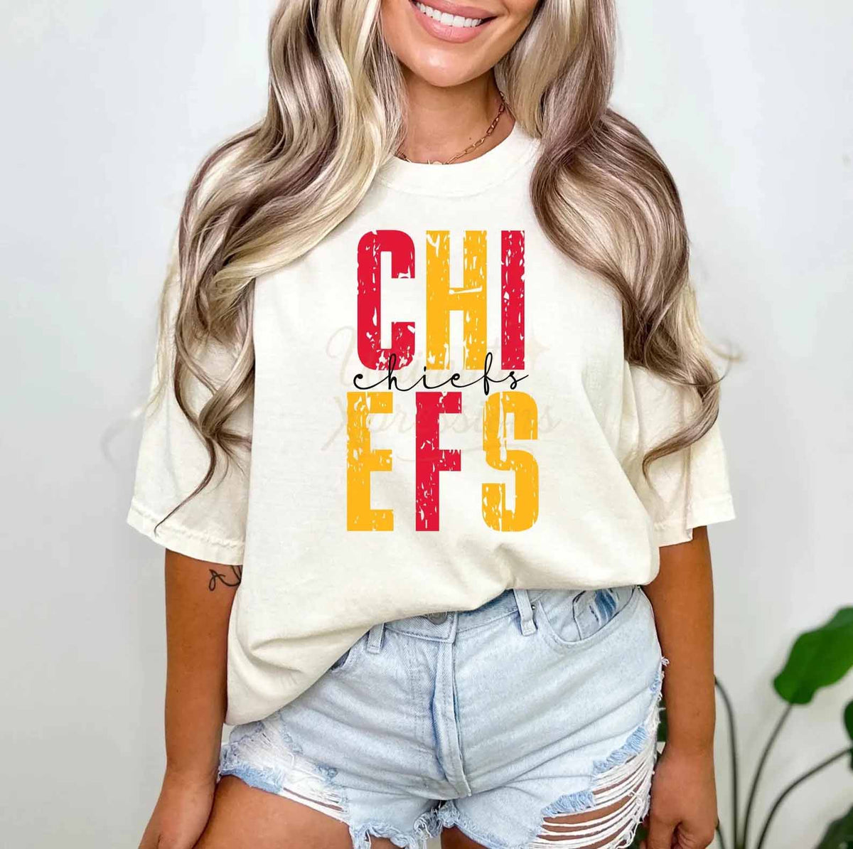 White graphic T-shirt with red and yellow Chiefs lettering on the chest