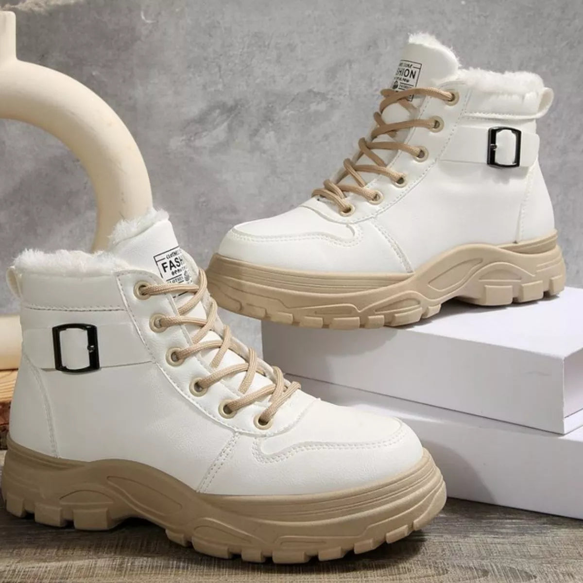 White warm-lined ankle boots with lace-up closure, side buckle, and thick sole