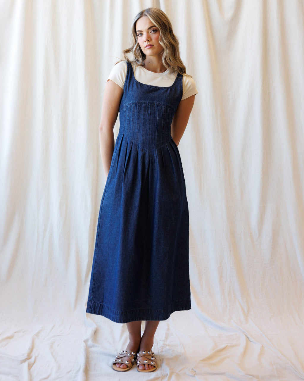 Medium-wash denim dress with square neckline and cap sleeves, gathered skirt