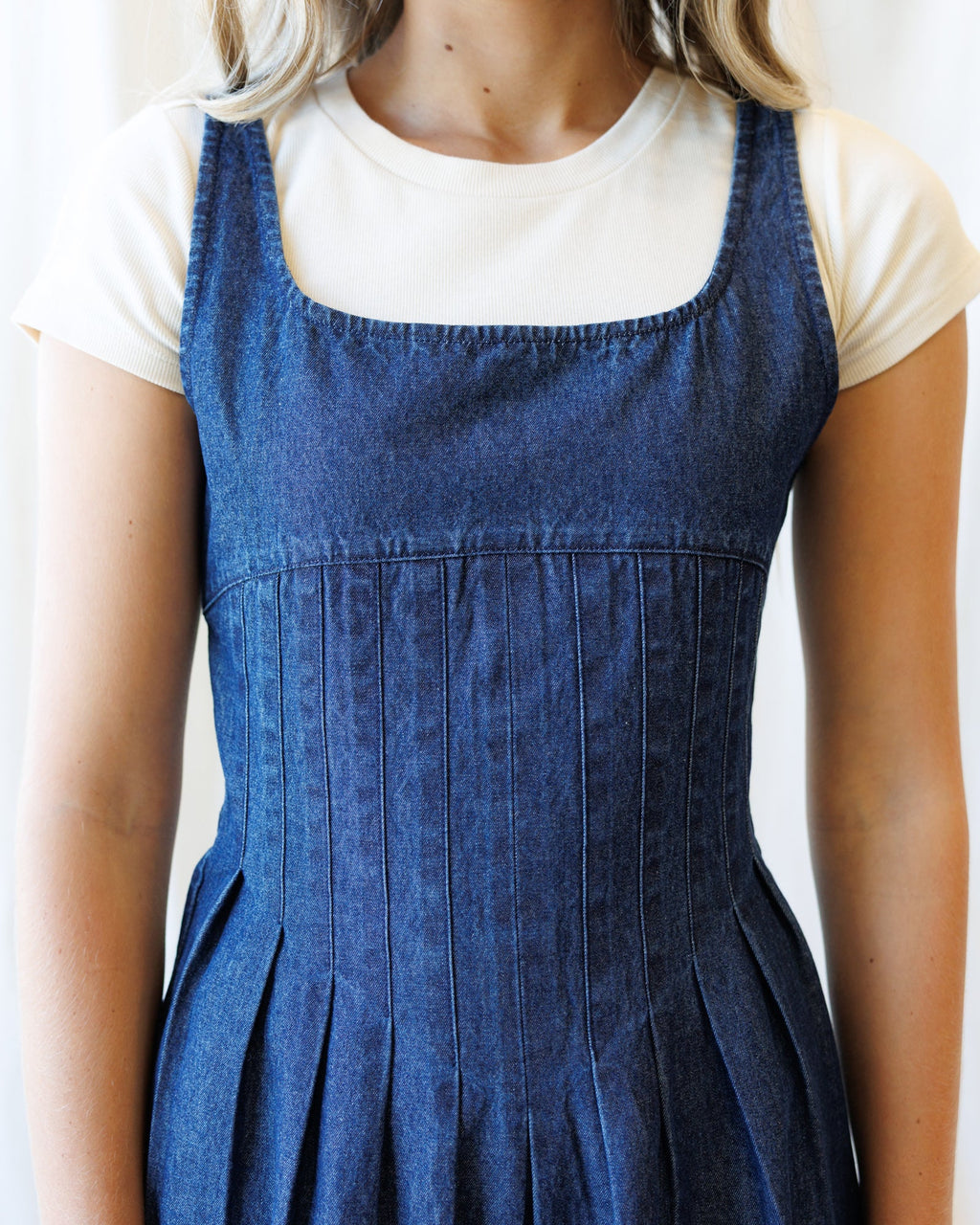 Denim dress bodice with vertical seam details and gathered skirt