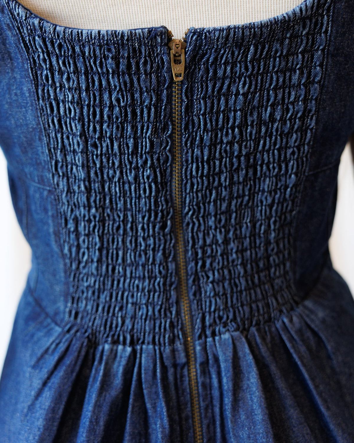 Denim dress back with centered zipper and smocked neckline