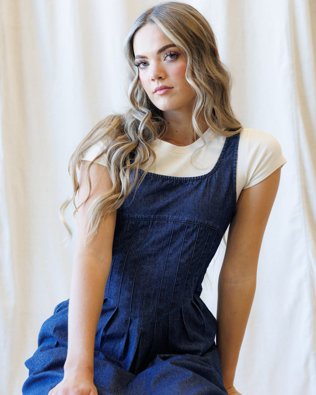 Denim pinafore-style dress with smocked bodice and square neckline
