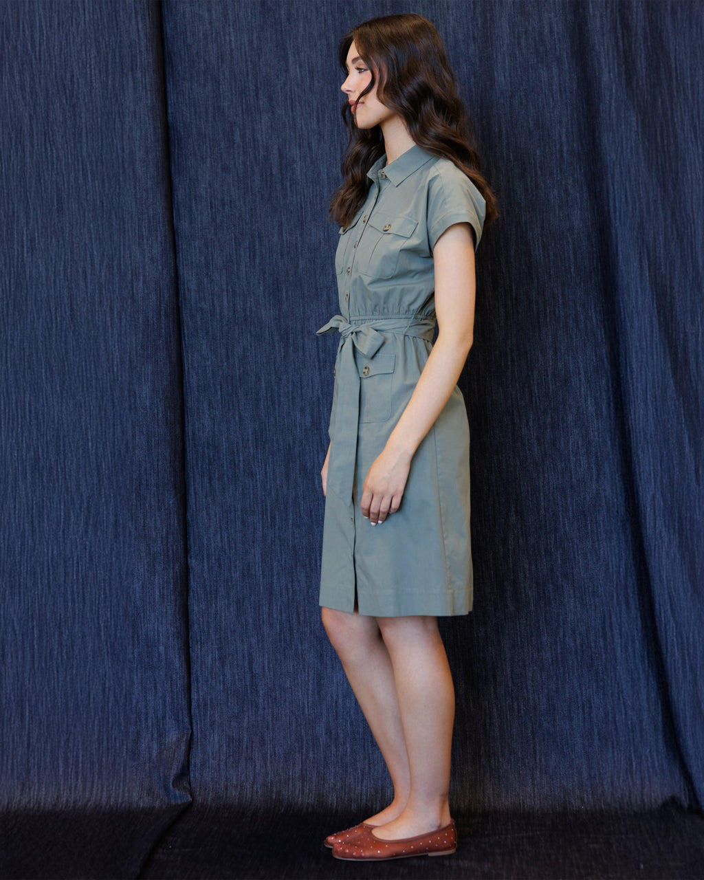 Button-front cap-sleeve dress with tie waist and chest pockets, side view, sage blue