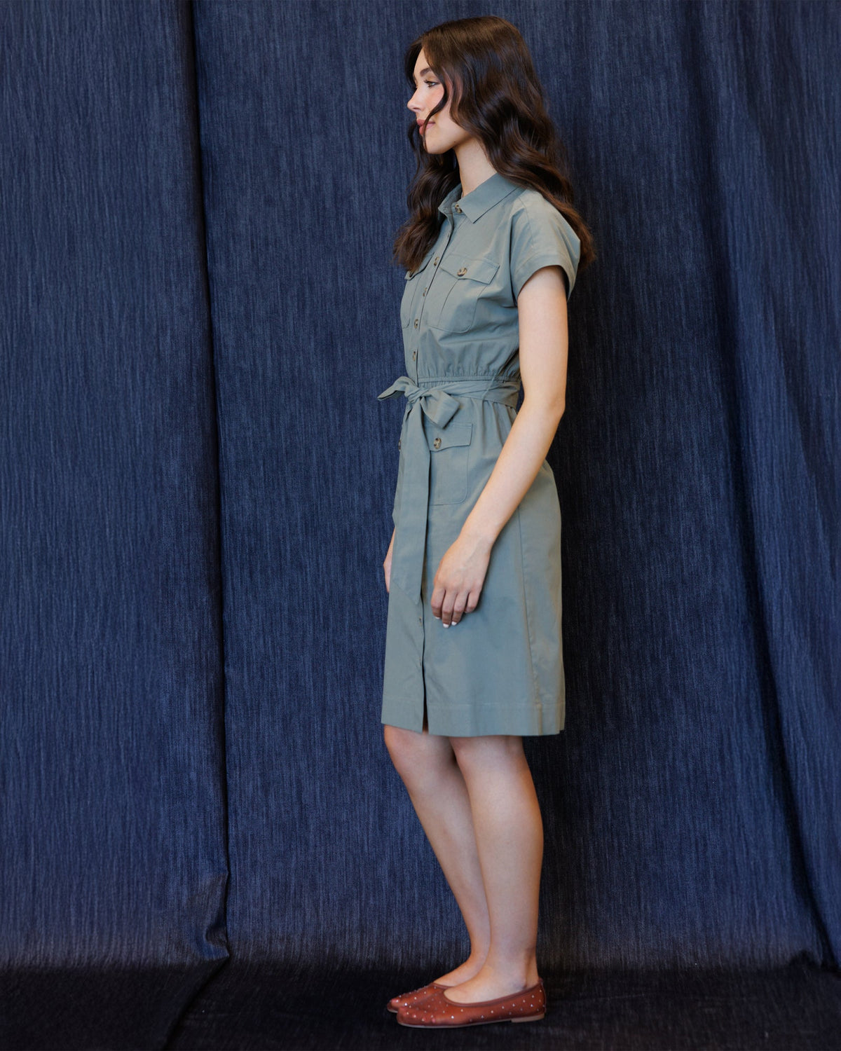 Button-front cap-sleeve dress with tie waist and chest pockets, side view, sage blue