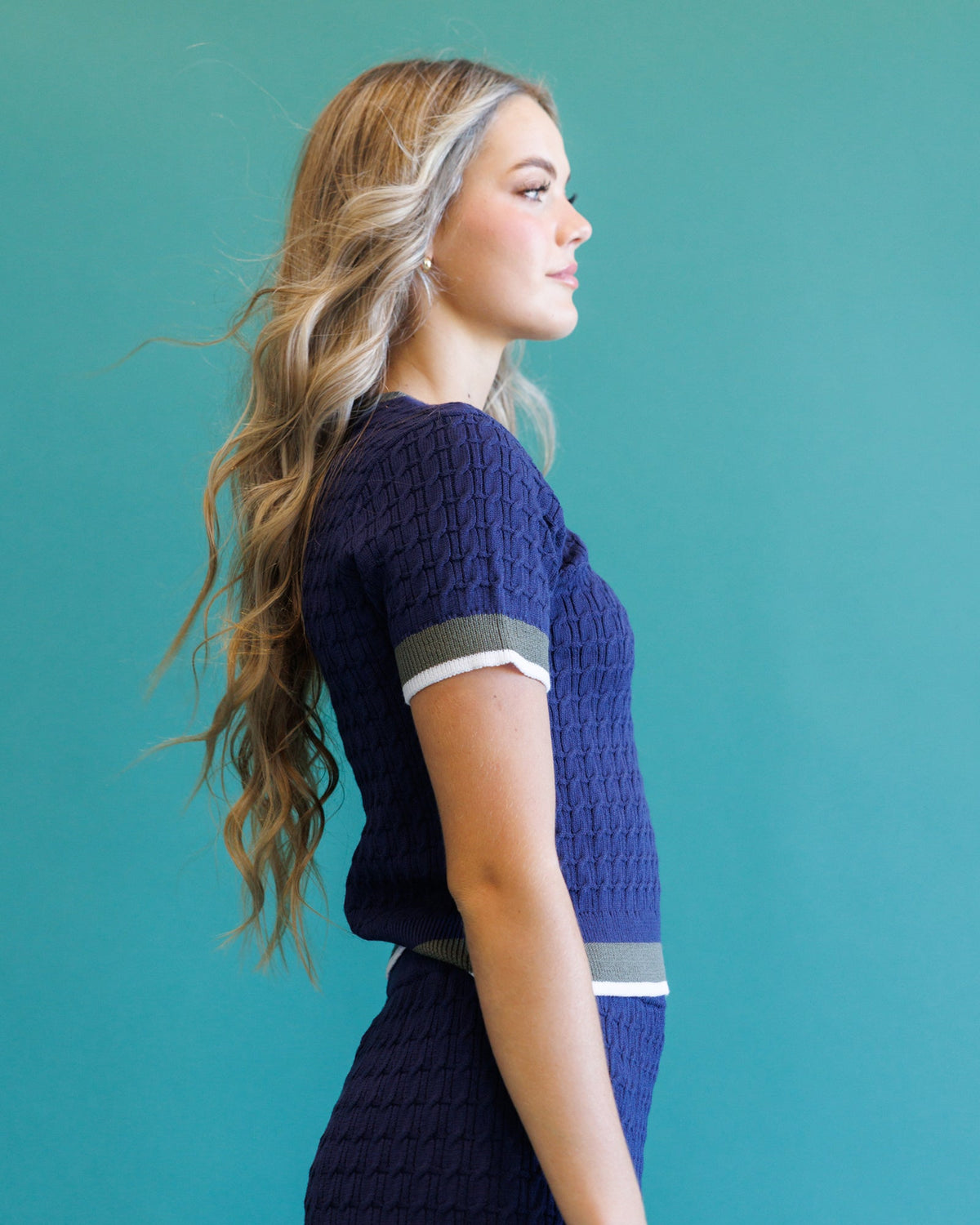 Dark blue cable-knit short-sleeve crewneck sweater with stripe rib trim on hem