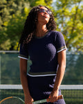 Dark blue cable-knit crewneck sweater with short sleeves and stripe rib trim