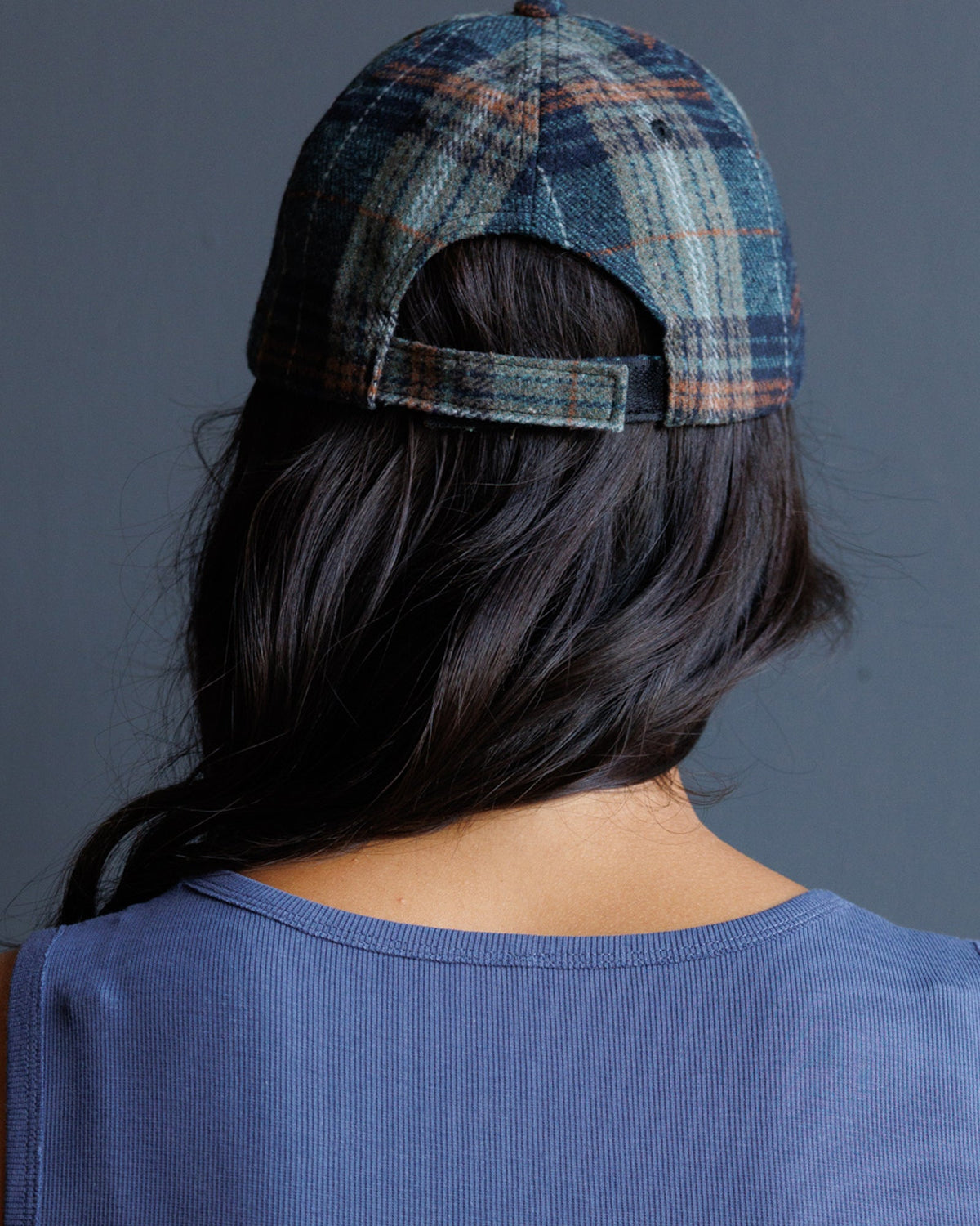 Plaid newsboy hat back view with adjustable strap and blue-orange tones