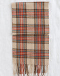 Plaid scarf in beige, rust, and muted teal with fringed ends