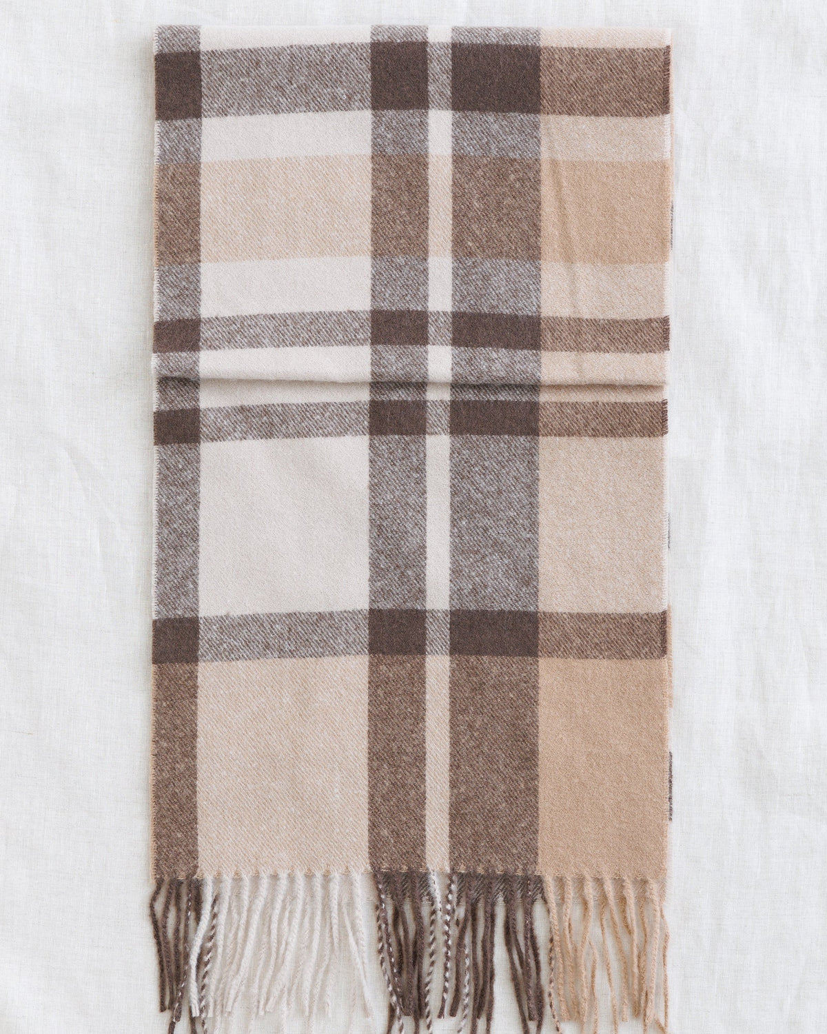 Plaid scarf swatch with cream, tan, and brown check pattern; fringed hem